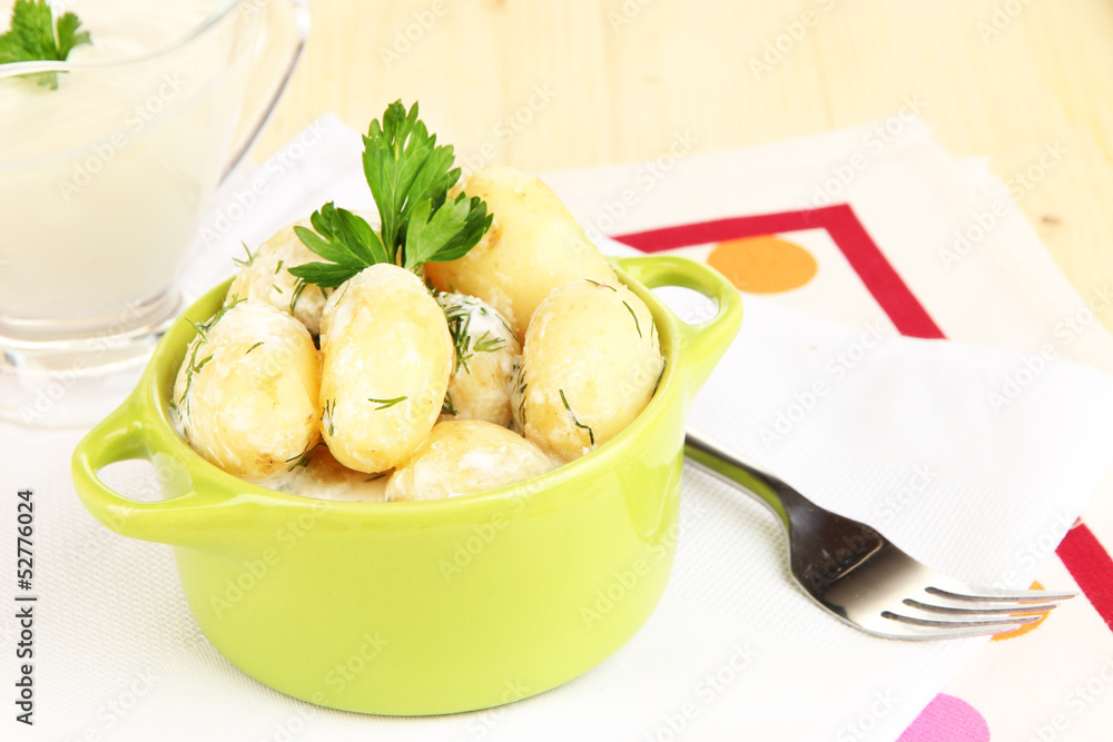 Tender young potatoes with sour cream and herbs in pan Tender young potatoes with sour cream and herbs in pan