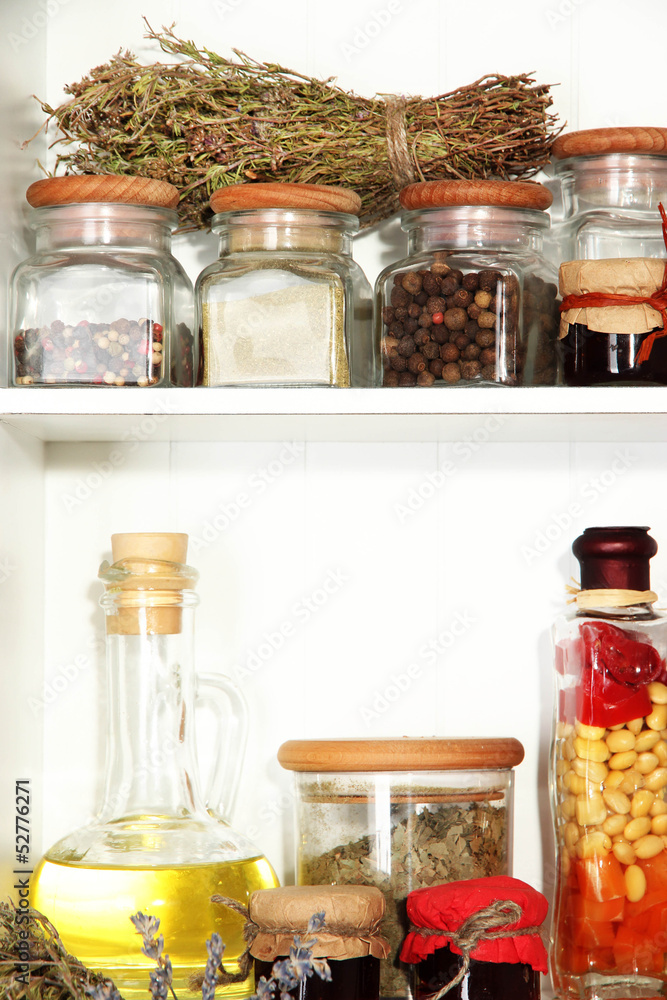 Variety spices on kitchen shelves close-up Variety spices on kitchen shelves close-up