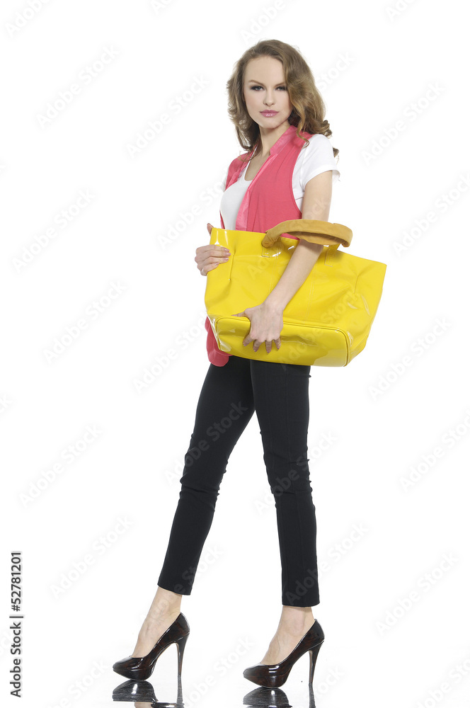 young woman holding yellow bag posing young woman holding yellow bag posing