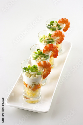 verrine salad with  cheese  served in glass with a shrimp on top