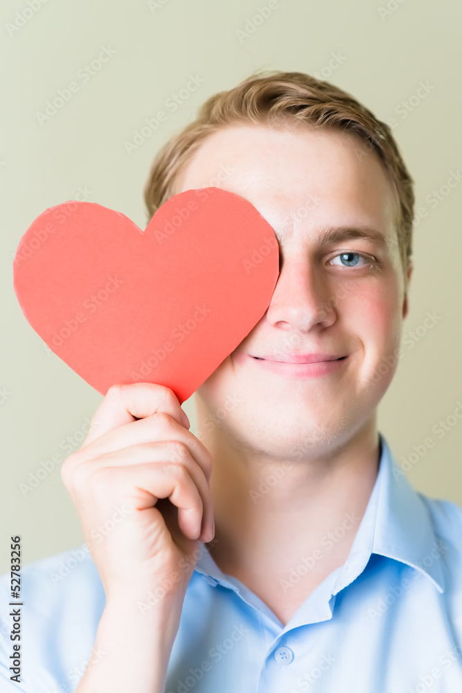 young guy holding a heart young guy holding a heart