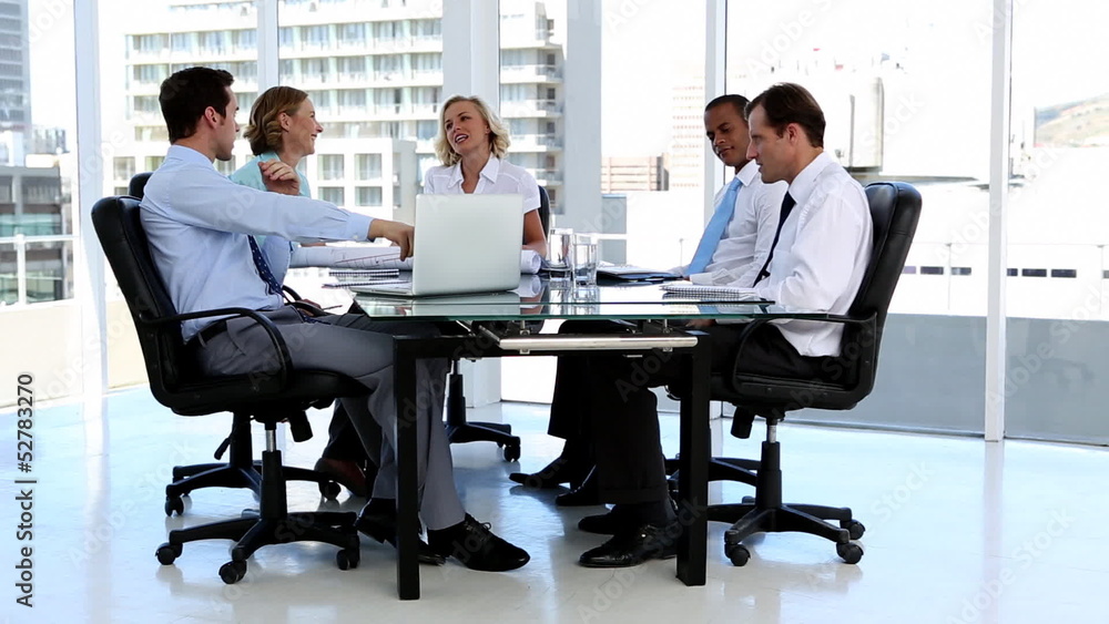 Business team talking around a desk Business team talking around a desk
