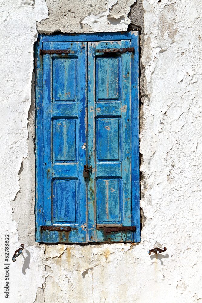 Old window with blue shutters from Mykonos island Old window with blue shutters from Mykonos island