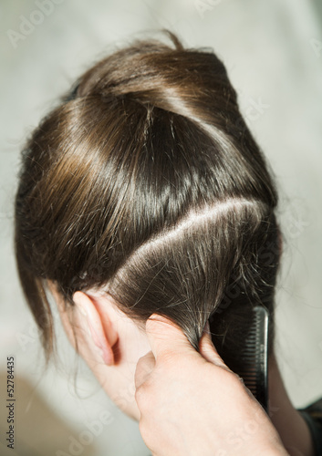 Closeup of combing back side hair part