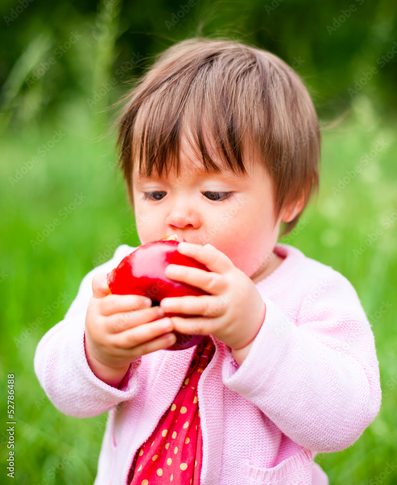 little girl eats an apple little girl eats an apple
