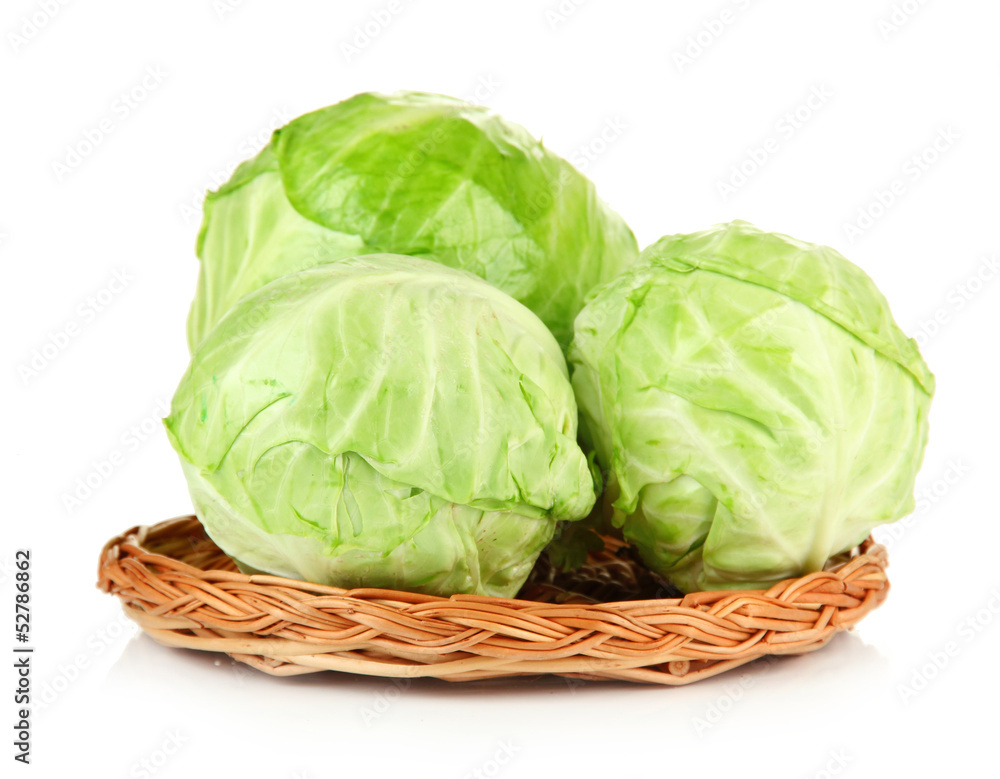 Fototapeta premium Green cabbage on wicker mat, isolated on white