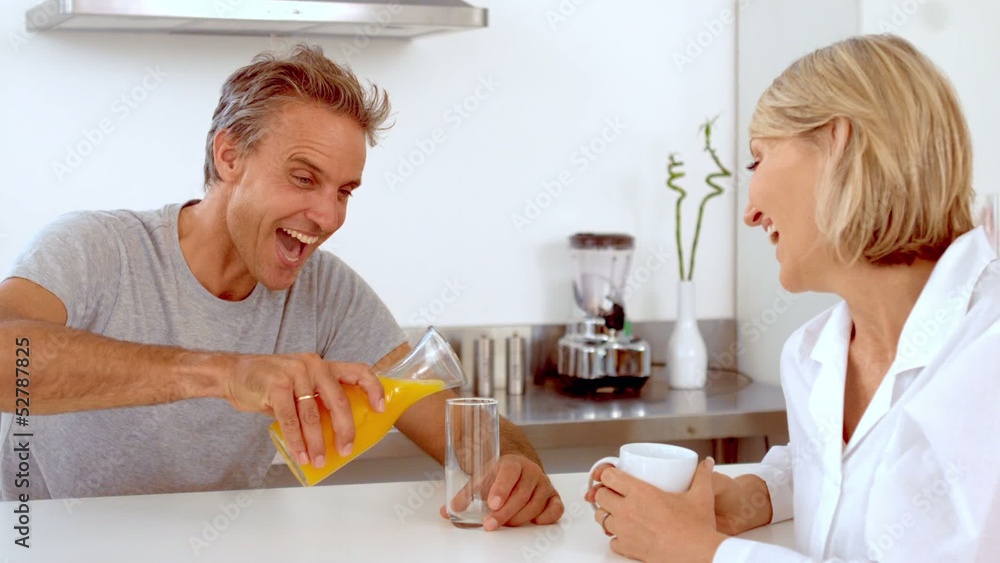 Cheerful man pouring orange juice Cheerful man pouring orange juice