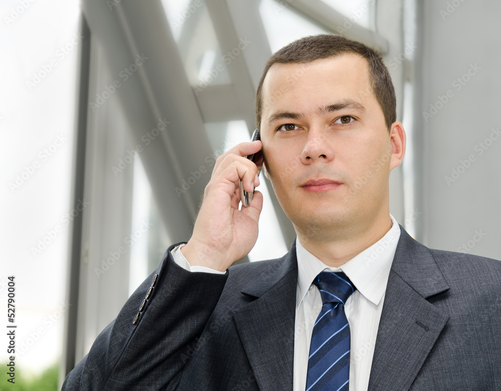 Portrait of young businessman calling by telephone Portrait of young businessman calling by telephone