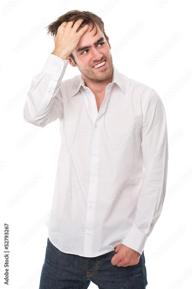 Handsome young man smiling with hand in hair Handsome young man smiling with hand in hair