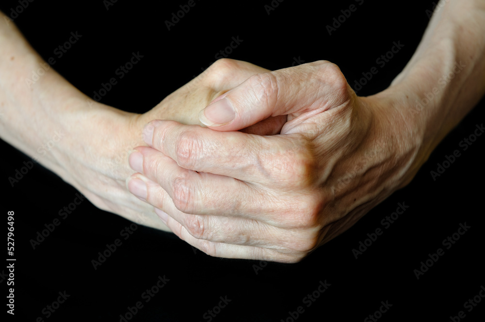 Senior woman's hands on black background Senior woman's hands on black background