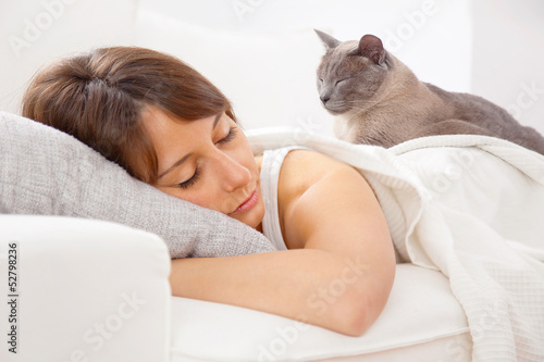 Portrait of a young woman sleeping on the bed