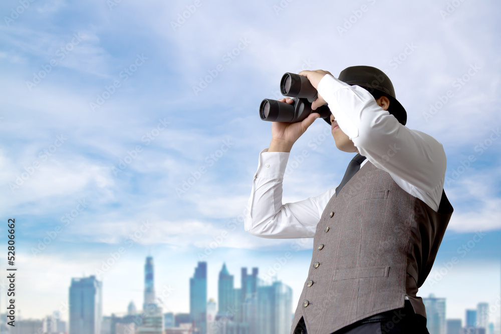 Businessman using binoculars.