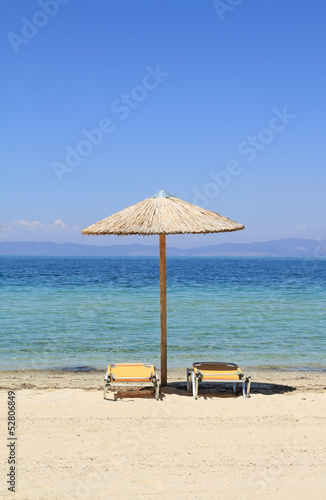 Umbrellas and recliners by the sea