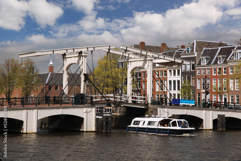 Amsterdam with boat against old bridge in Holland