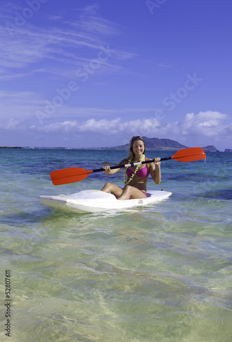 girl paddling a surfski © tomas del amo