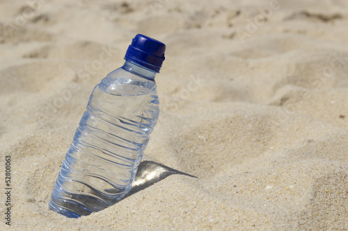 Bottle of water on the sand