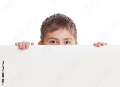 Fotografia Boy emerge from behind poster