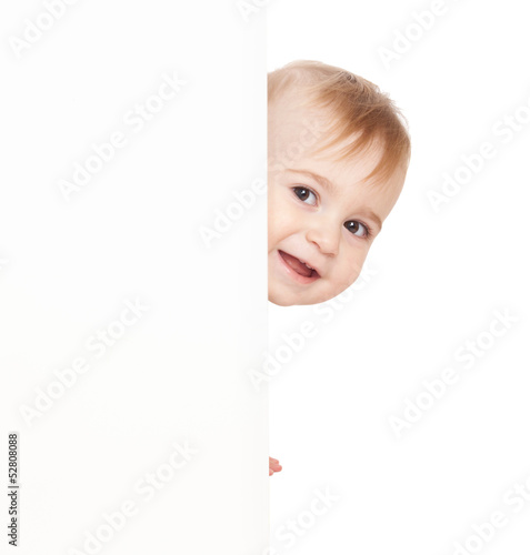Fotografie Boy emerge from behind poster.