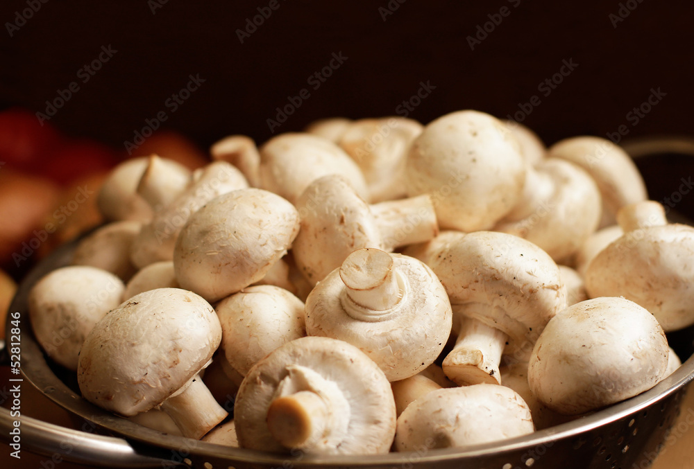 Fresh mushrooms in colander