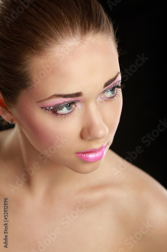 Woman eye with exotic style makeup, isolated on black background