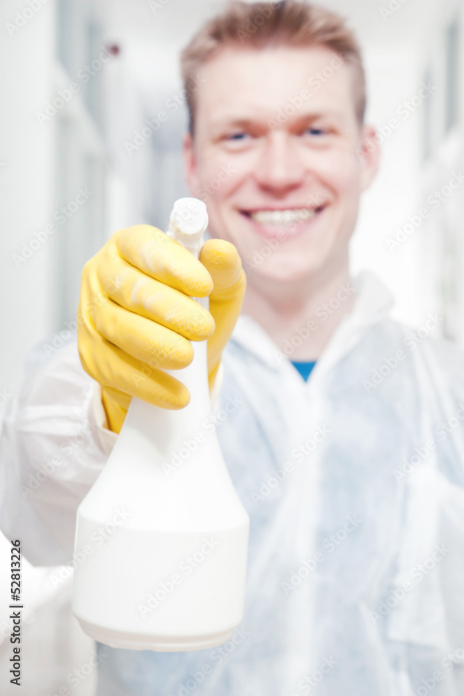 Office cleaner man pointing camera with spray bottle Stock Photo | Adobe  Stock