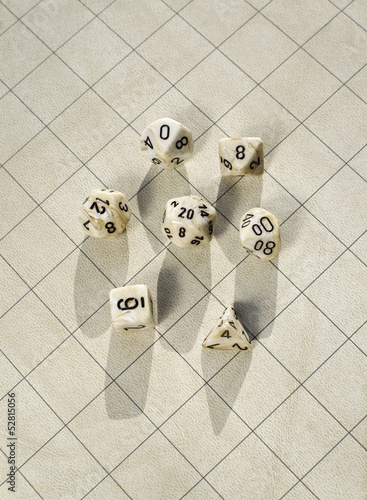 Polyhedral dice on blank square grid game map used in game