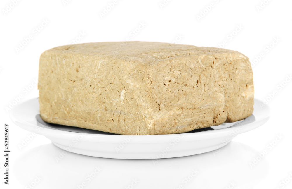 Tasty halva on plate isolated on white Tasty halva on plate isolated on white