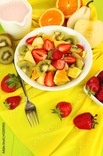 Useful fruit salad of fresh fruits and berries in bowl