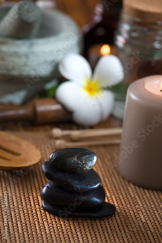 hot stone massage with spa treatment items on the background