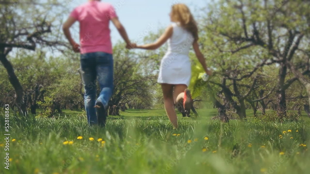 romantic couple of lovers run in the garden romantic couple of lovers run in the garden