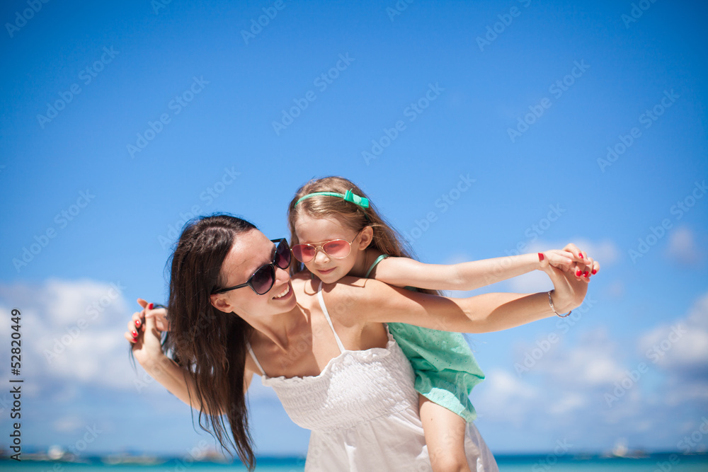 Young beautiful mother and her adorable little daughter at Young beautiful mother and her adorable little daughter at