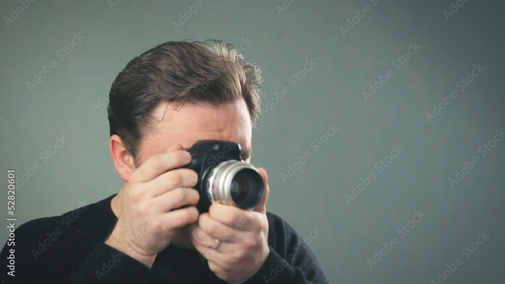 photographer takes shots, setting manual focus photographer takes shots, setting manual focus