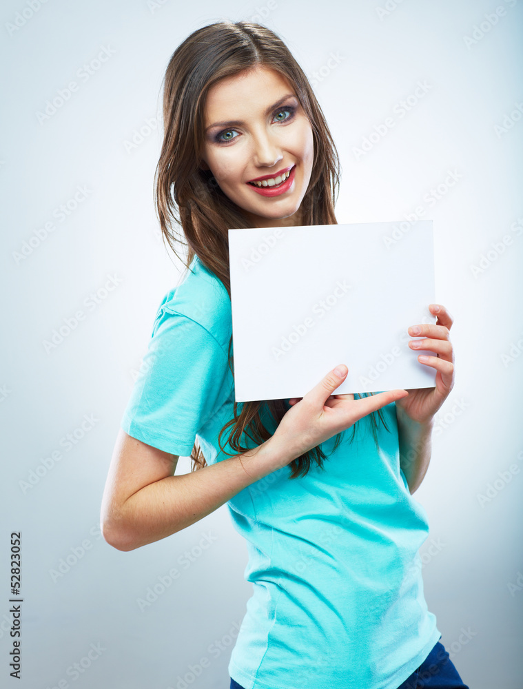 Teenager girl hold white blank paper. Young smiling woman show Teenager girl hold white blank paper. Young smiling woman show