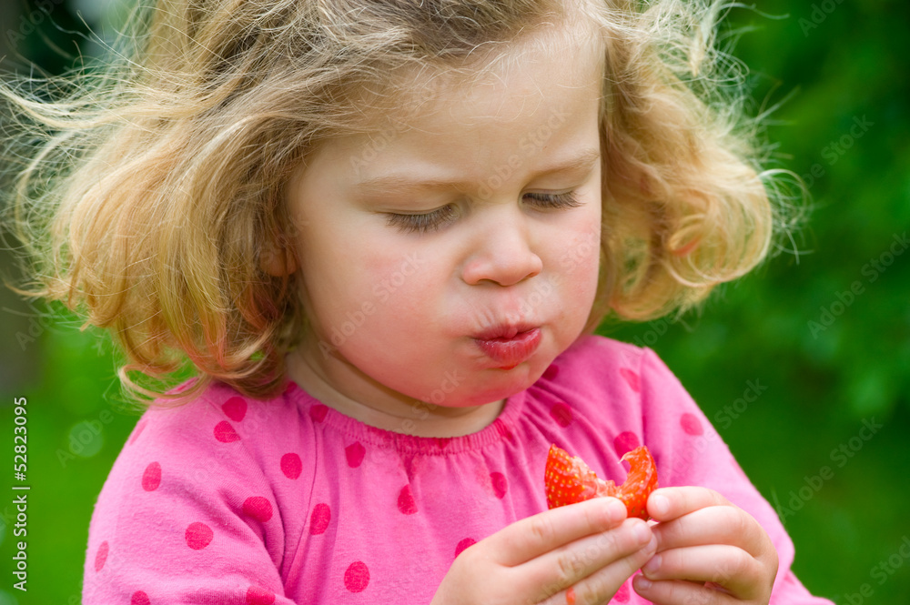 little girl is eating strawberry little girl is eating strawberry
