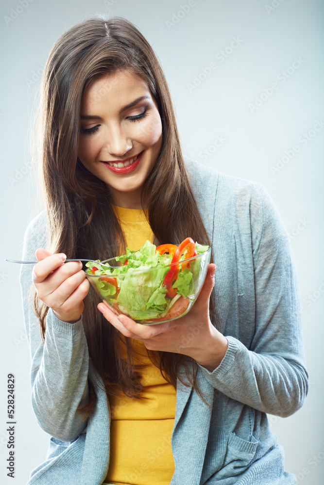 Young woman eating salad isolated Young woman eating salad isolated