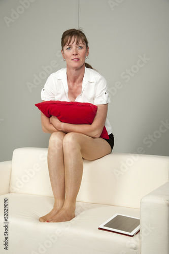 Принти на полотні Woman wearing short skirt sitting on a sofa