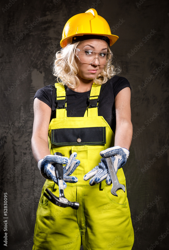 Attractive builder woman with a drill in her hands Attractive builder woman with a drill in her hands