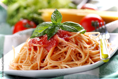 spaghetti al pomodoro con foglia di basilico photo