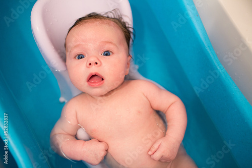 Baby washing in blue bath