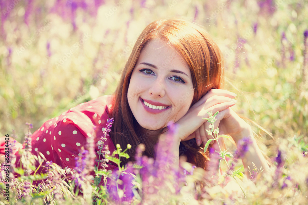 Redhead girl at green grass at village outdoor Redhead girl at green grass at village outdoor