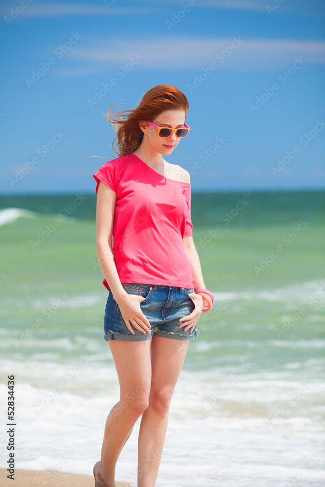 Redhead teen girl on the beach