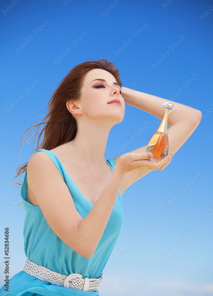 Redhead girl with perfume on the beach
