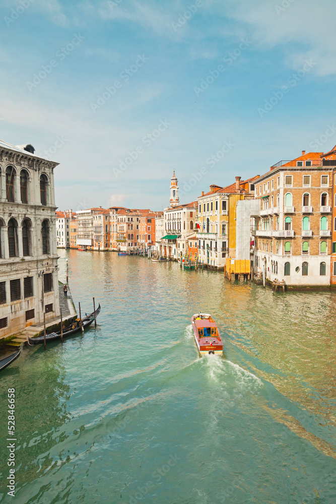 Fototapeta premium Colorful canal of Venice with houses and boat. View from Rialto