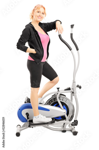 Mature woman athlete on a cross trainer fitness machine