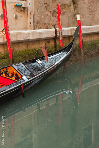 Venetian gondola boat in canal. Venice. Italy.