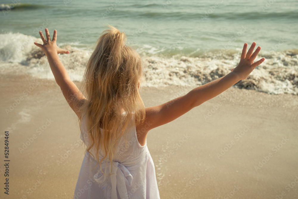 happy little girl standing on beach happy little girl standing on beach