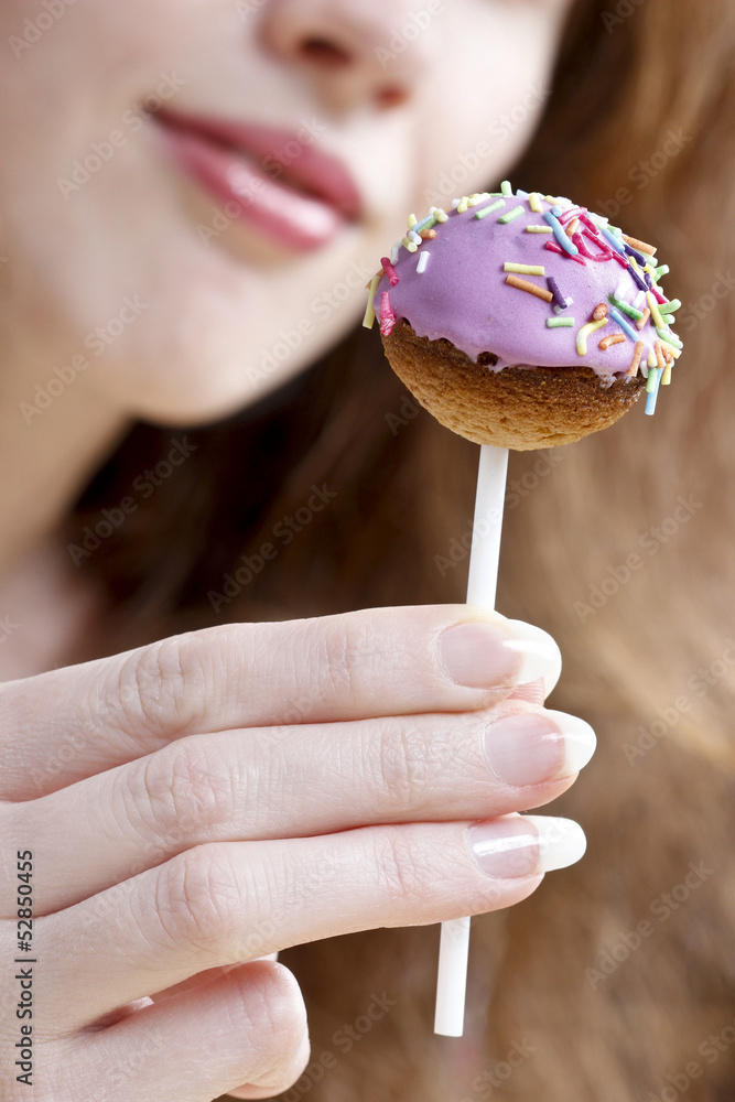 Girl with wonderful smile holding cake pops Girl with wonderful smile holding cake pops