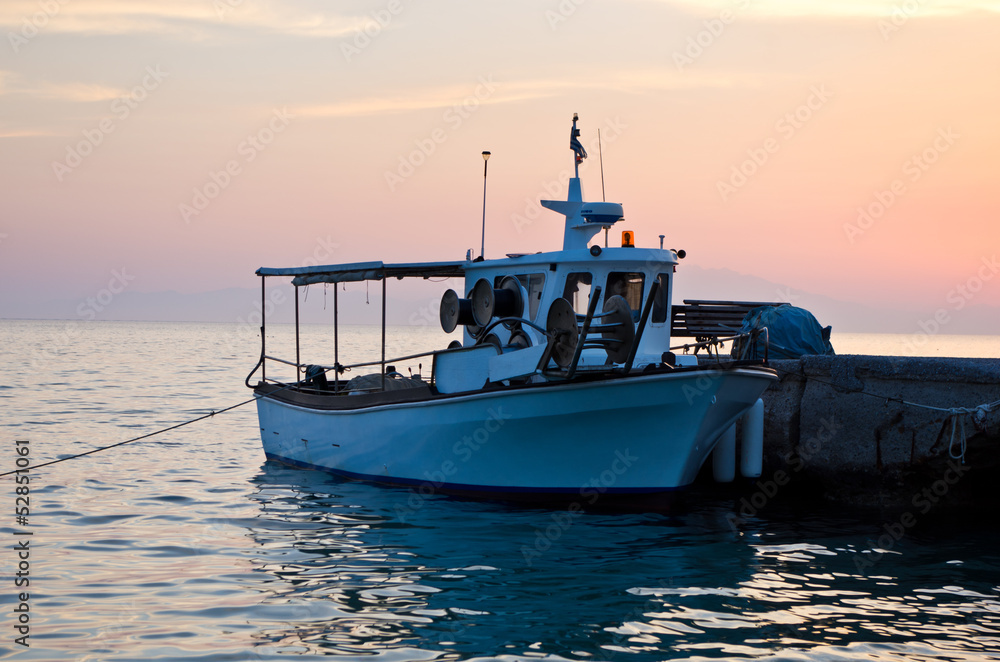 Fishing boat at the dock in sunset