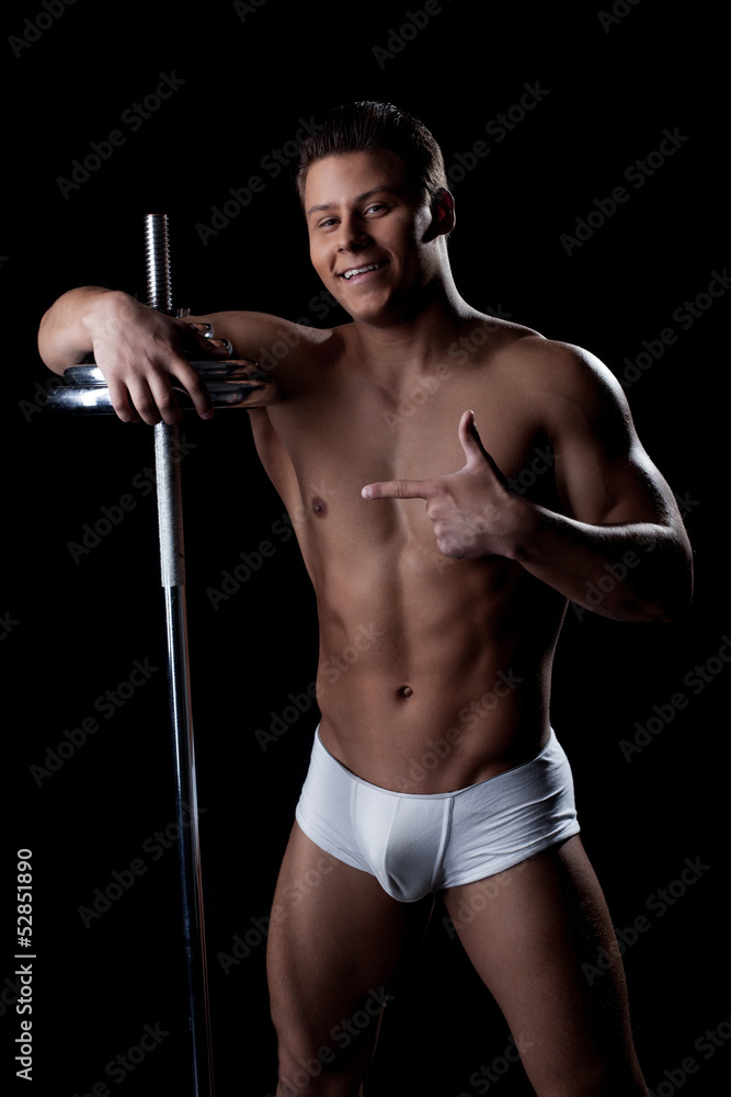 Portrait of cheerful athlete posing with barbell Portrait of cheerful athlete posing with barbell
