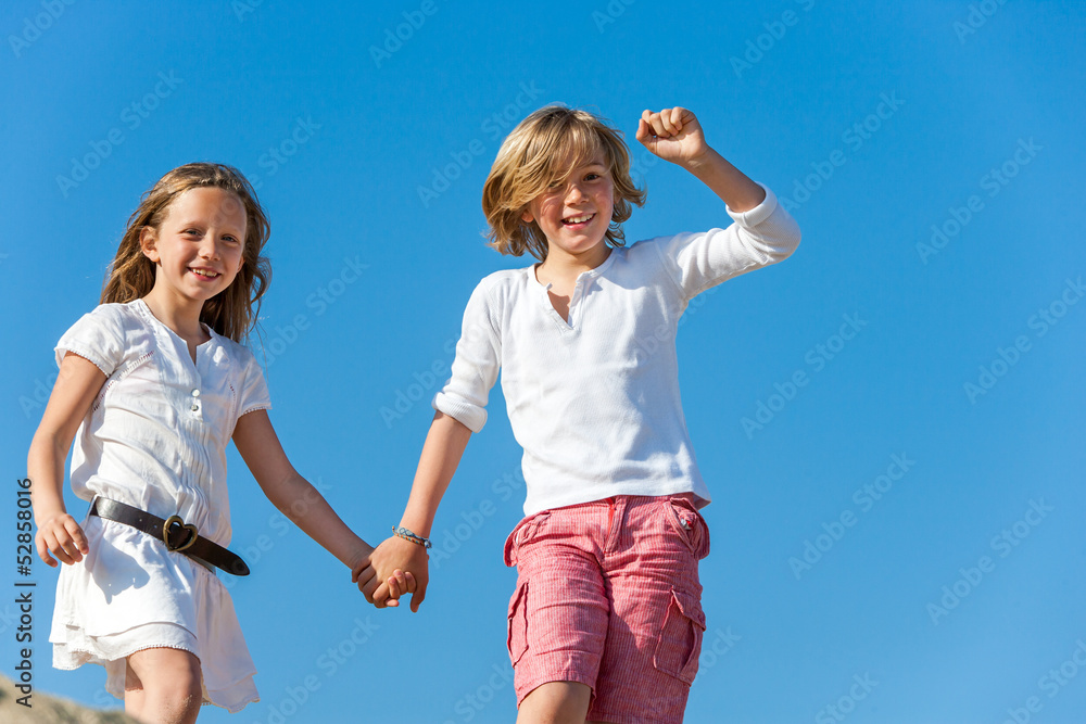 Happy kids holding hands outdoors. Happy kids holding hands outdoors.